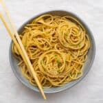 cold sesame noodles swirled in a bowl with chop sticks
