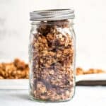vanilla almond granola in a mason jar with the pan in the background