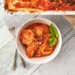 bowl of ravioli lasagna with a basil sprig