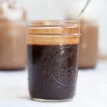 mason jar of chocolate syrup with a spoon