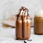 iced mocha withe whipped cream and chocolate syrup drizzled everywhere