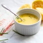 ramekin of lemon butter with cut lemons