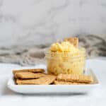 mason jar with cake better dip on a plate with graham cracker dippers