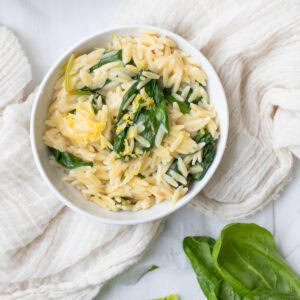 bowl of spinach lemon orzo in a white bowl