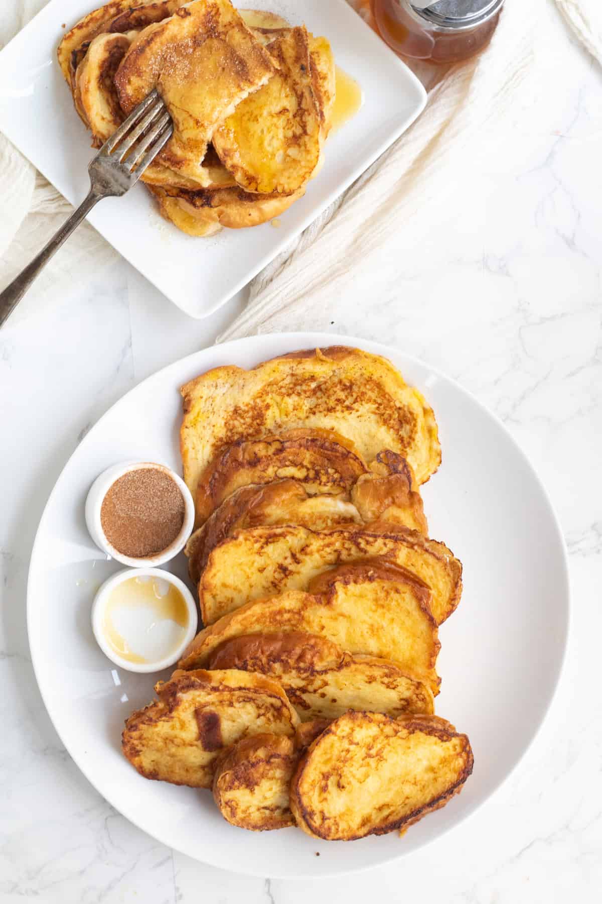 french toast on a plate with syrup and cinnamon sugar