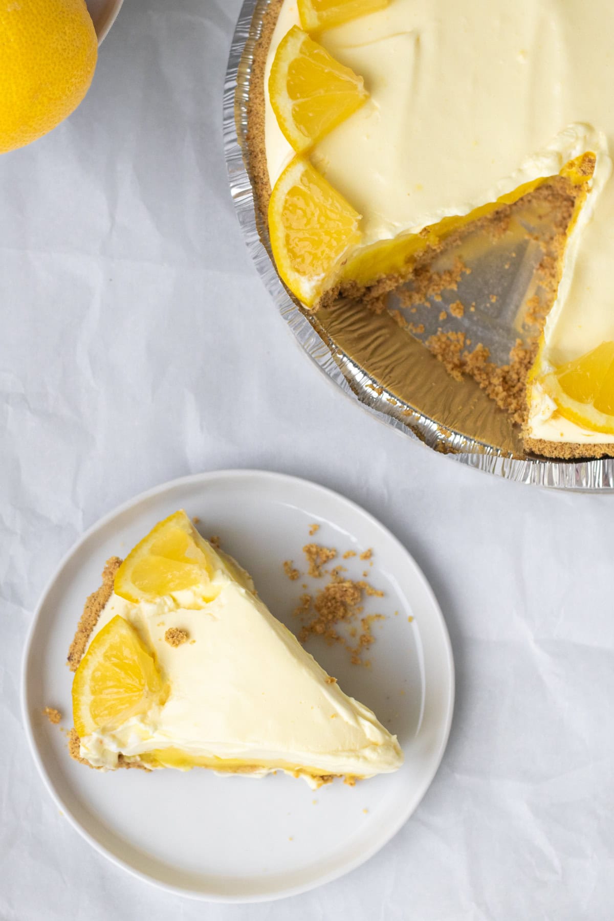 a piece of lemon pudding pie cut from a whole pie