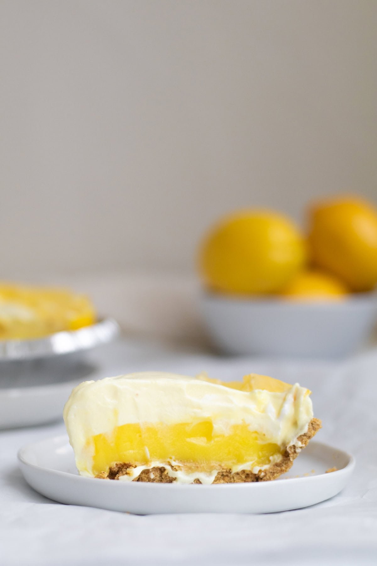 piece of lemon pudding pie on a white plate