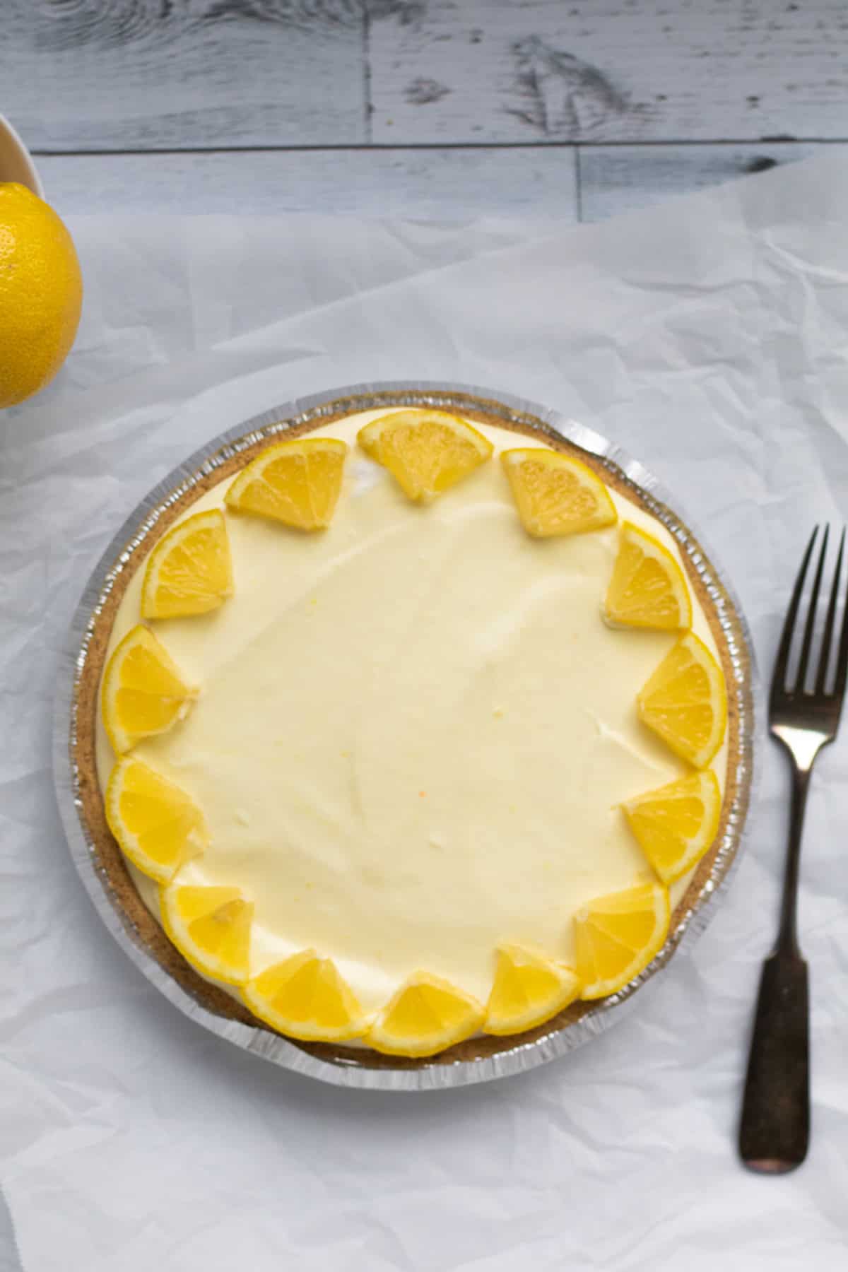 whole lemon pie garnished with lemon wedges