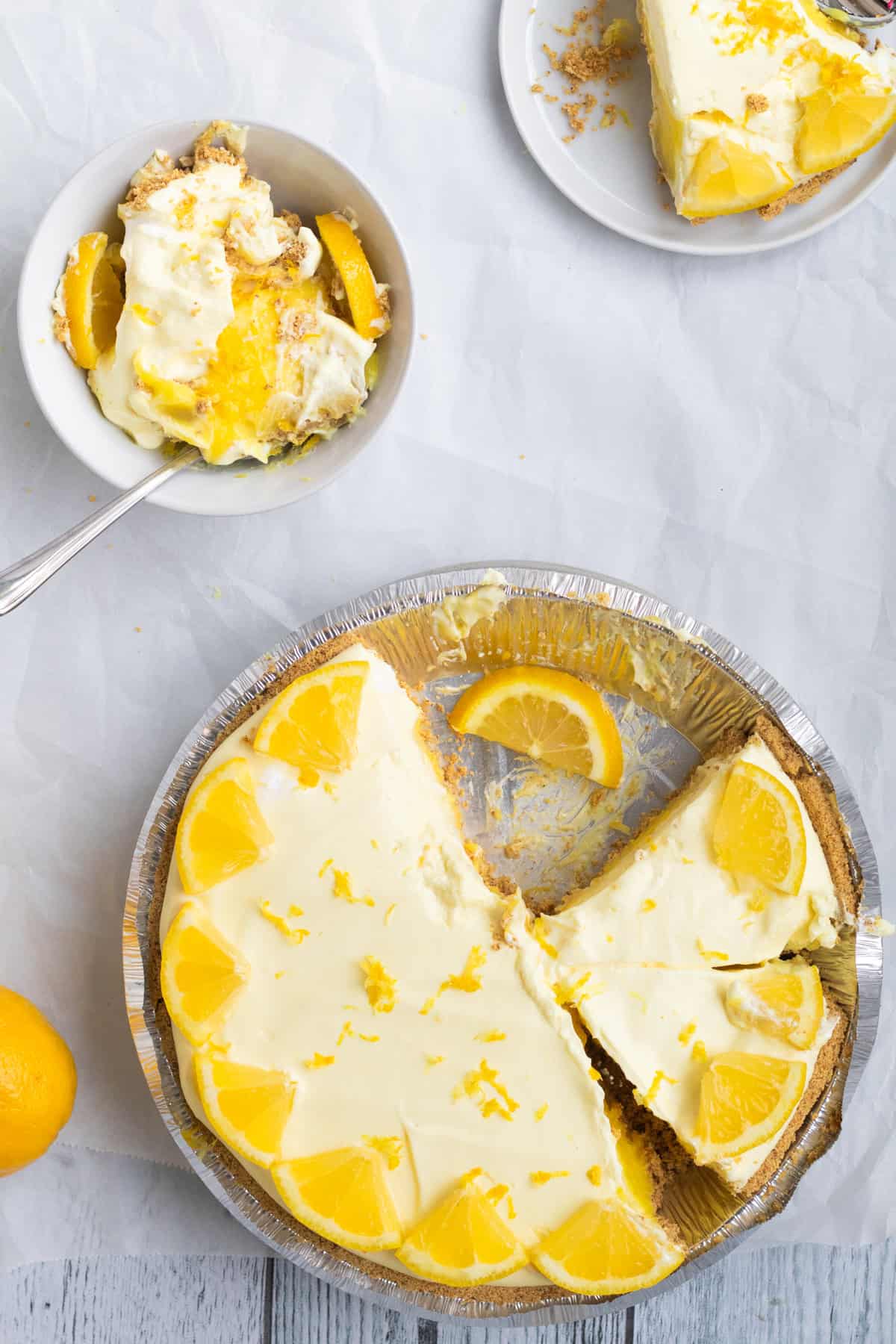 lemon pie sliced with a broken slice in a bowl