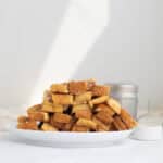 a pile of french toast sticks on a white plate