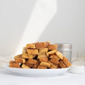 a pile of french toast sticks on a white plate