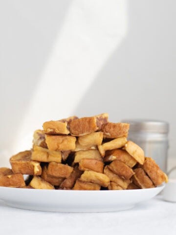 a pile of french toast sticks on a white plate
