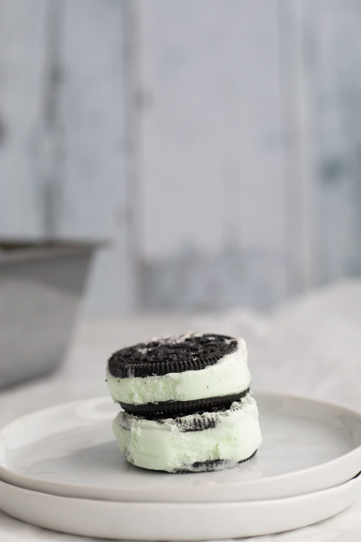 mint chip ice cream sandwiches stacked on a plate