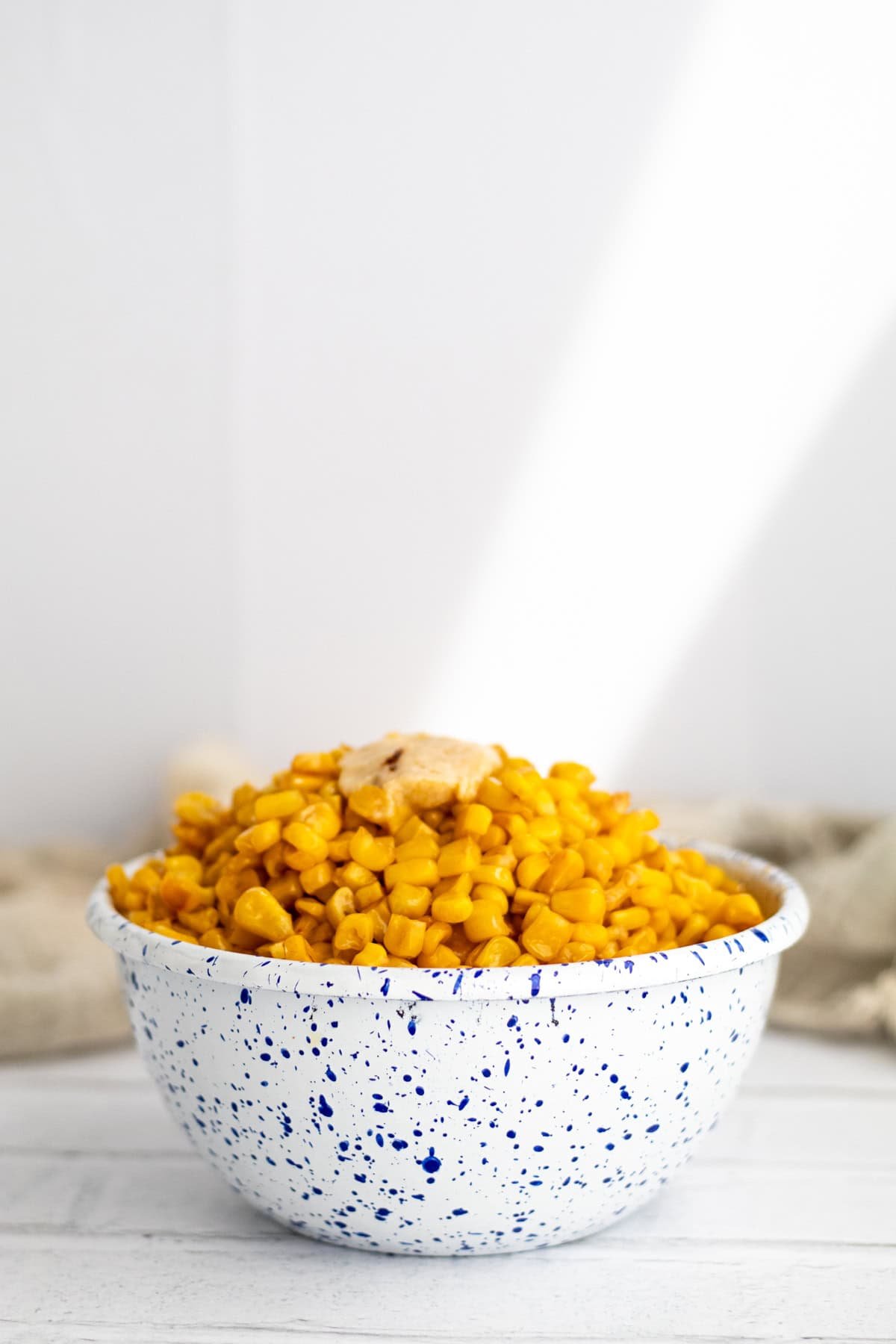 miso butter corn in a blue and white speckled bowl