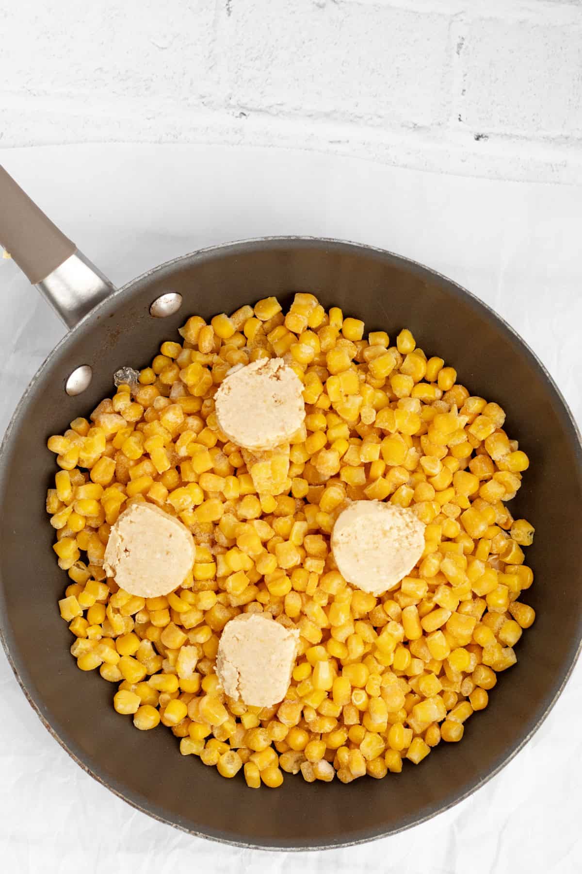 miso butter being added to cooked corn