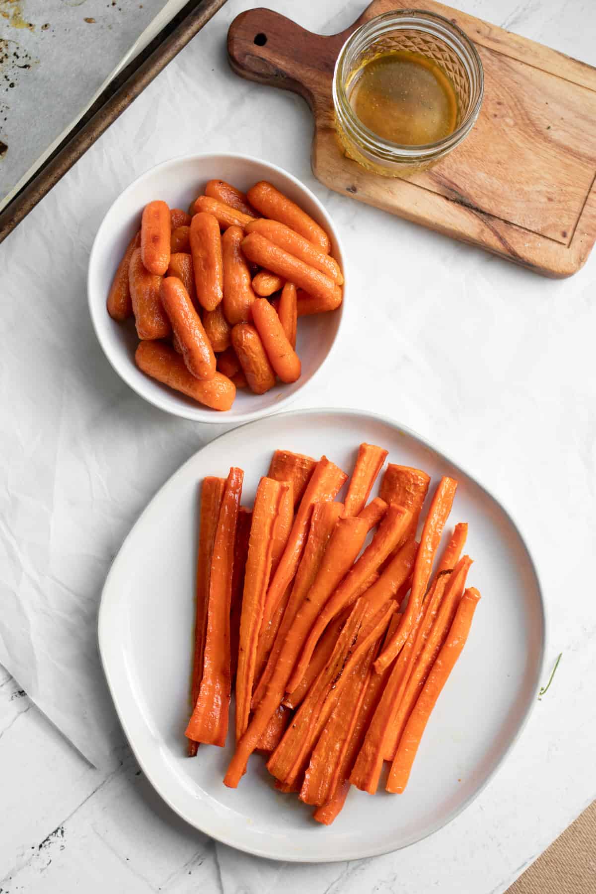 honey glazed carrots and baby carrots in serving dishes.