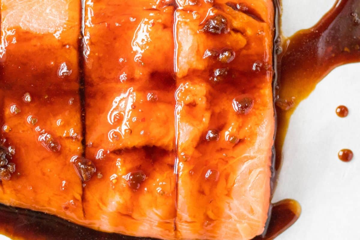 Sesame ginger sauce on top of raw salmon.
