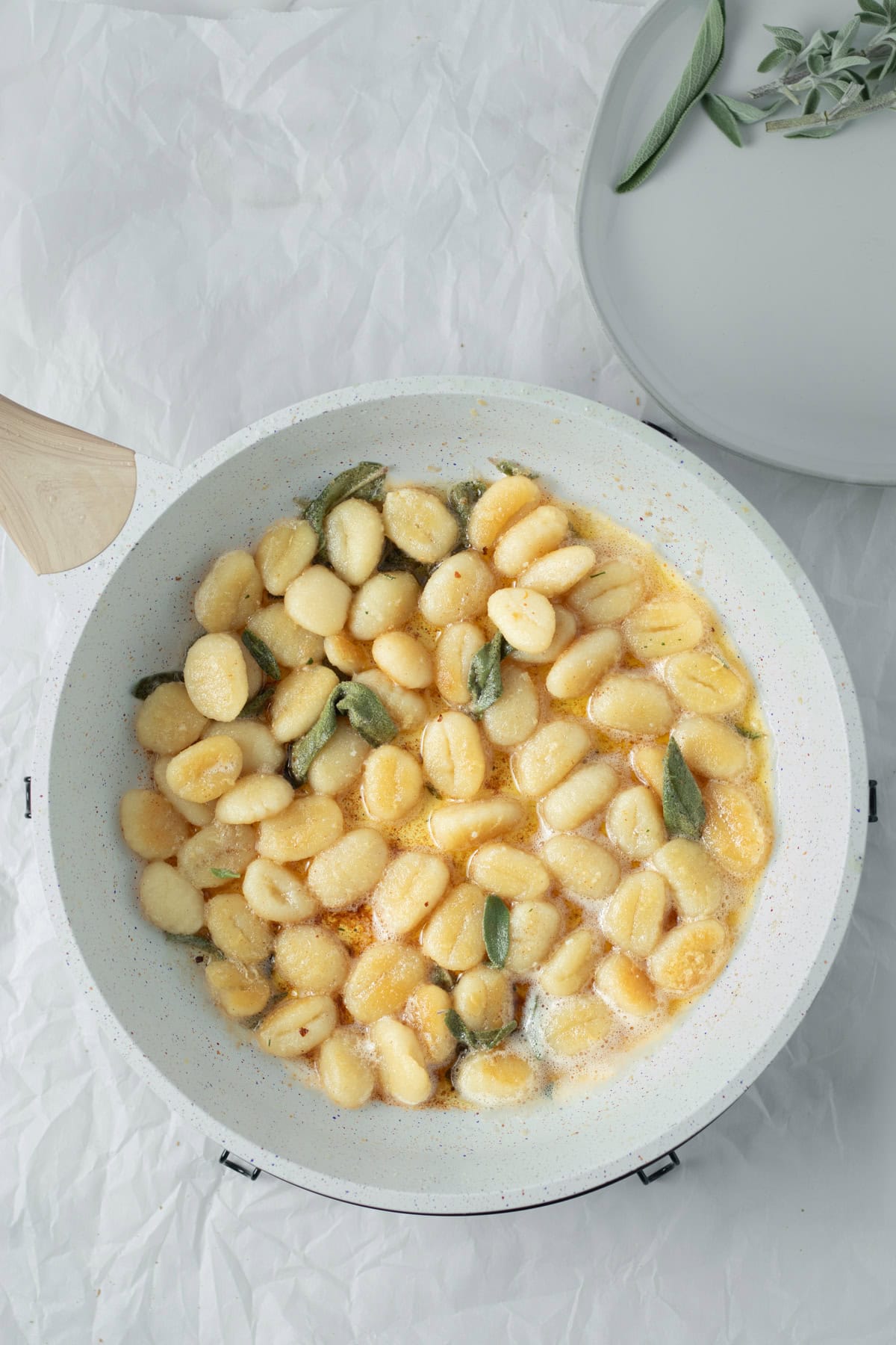 gnocchi being tossed in brown butter and sage.