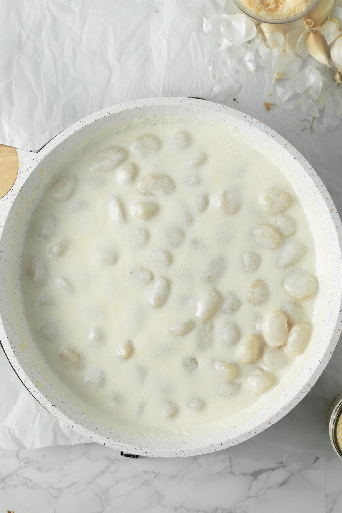 Gnocchi cooking in an alfredo sauce.