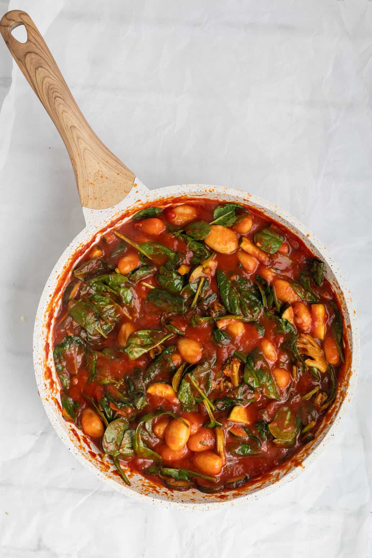 gnocchi with vegetables and marinara sauce in a pan.