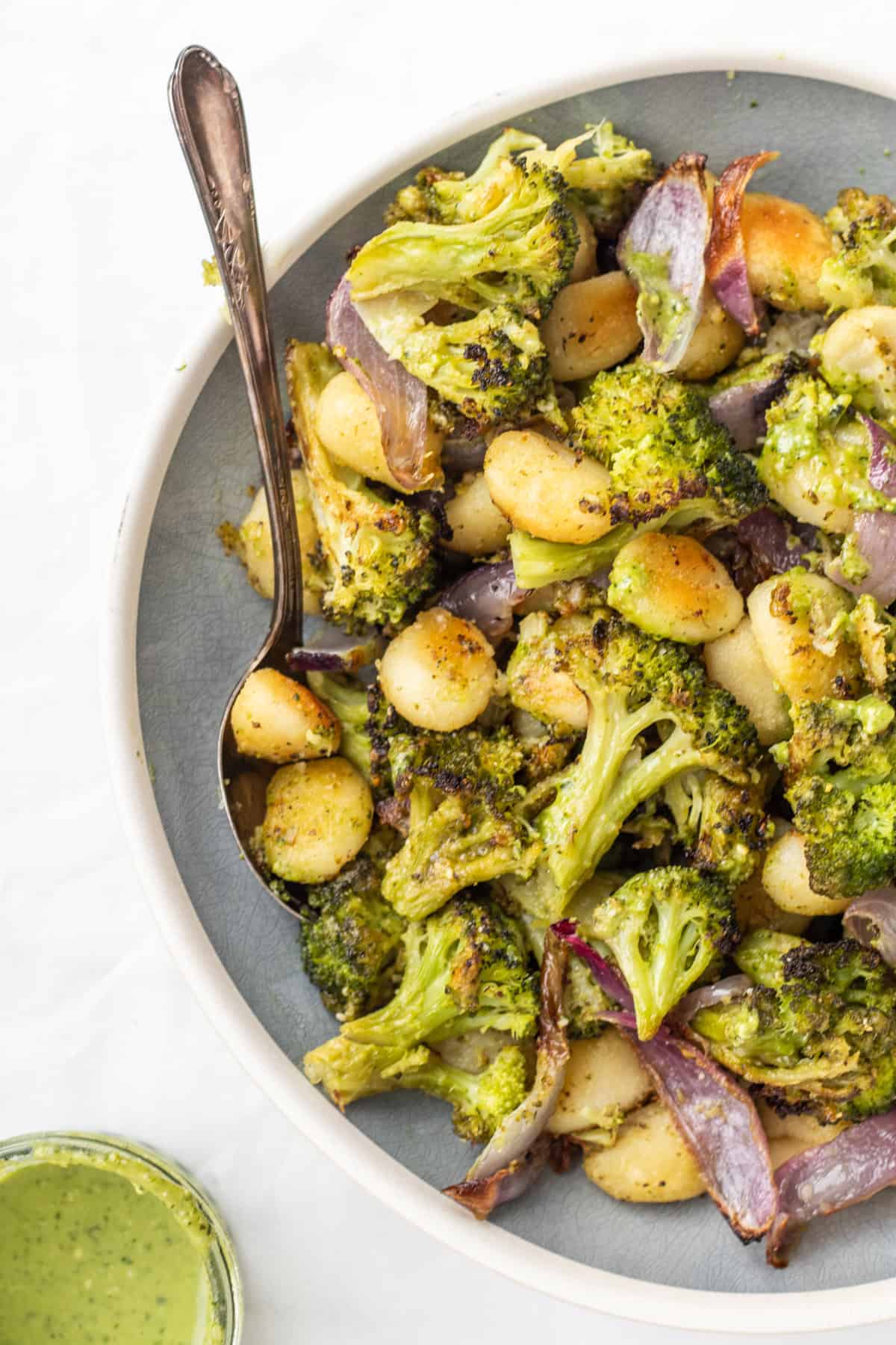 sheet pan gnocchi in a bowl with a spoon.
