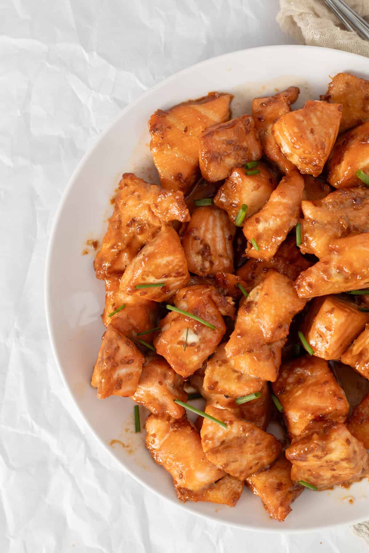 salmon bites on a white plate.