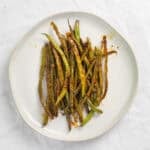 teriyaki green beans on a white plate.