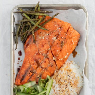 Teriyaki Salmon on a sheet pan with rice and vegetables.