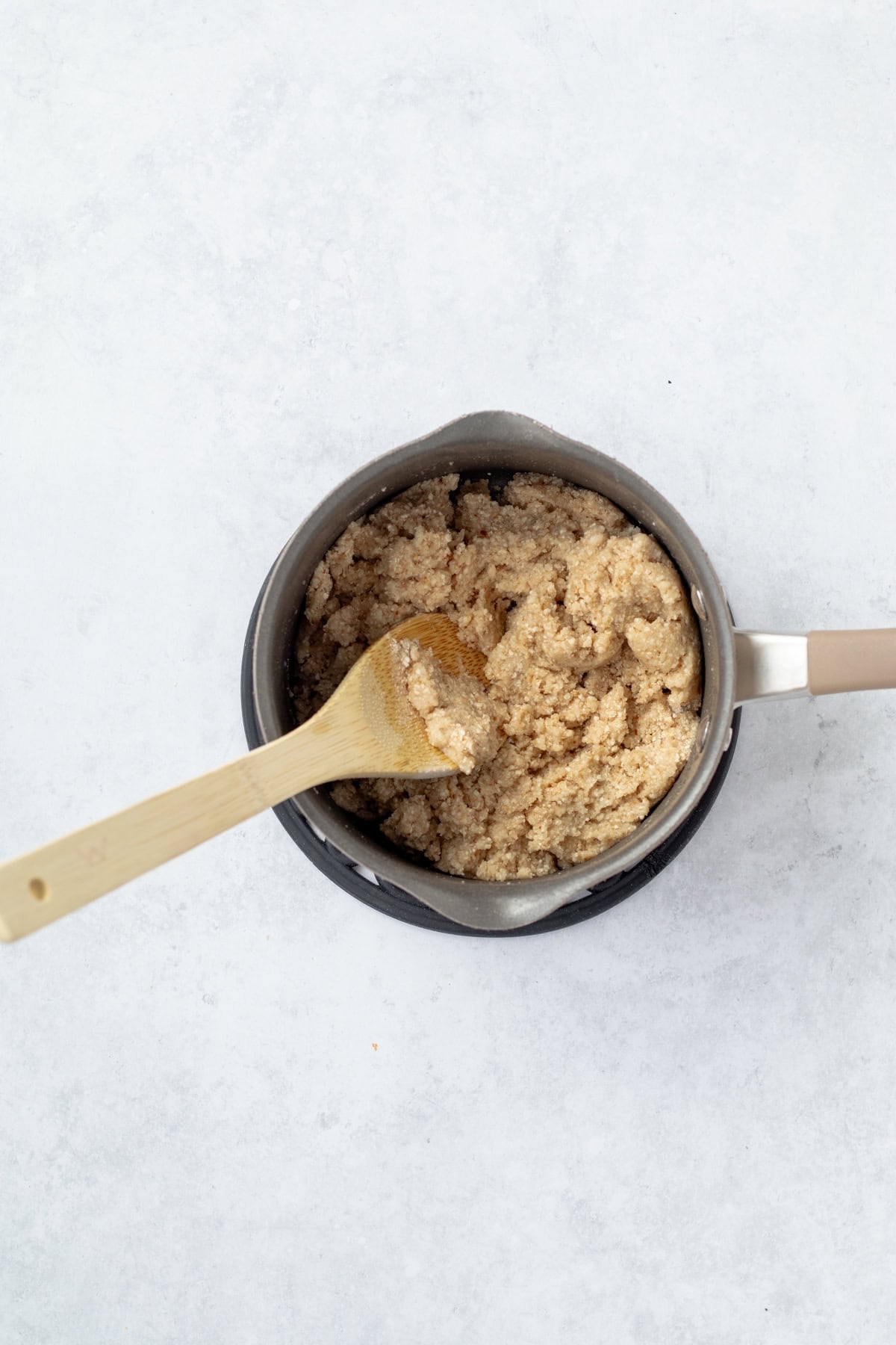 Stirring matzo meal in a pot.