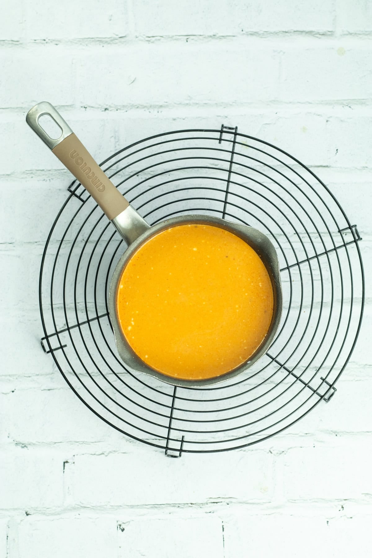 Homemade red curry sauce in a sauce pan.