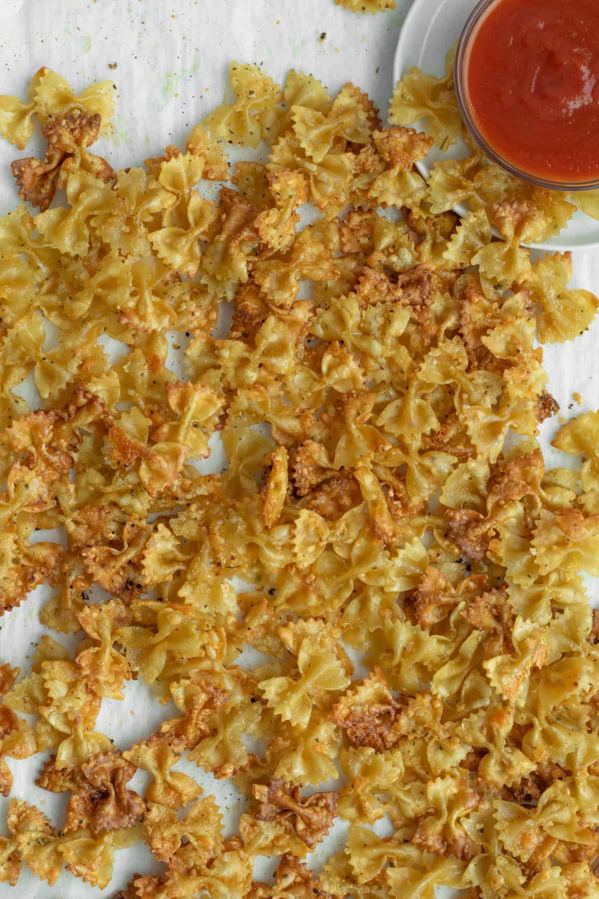pasta chips on a sheet tray with dipping sauce.