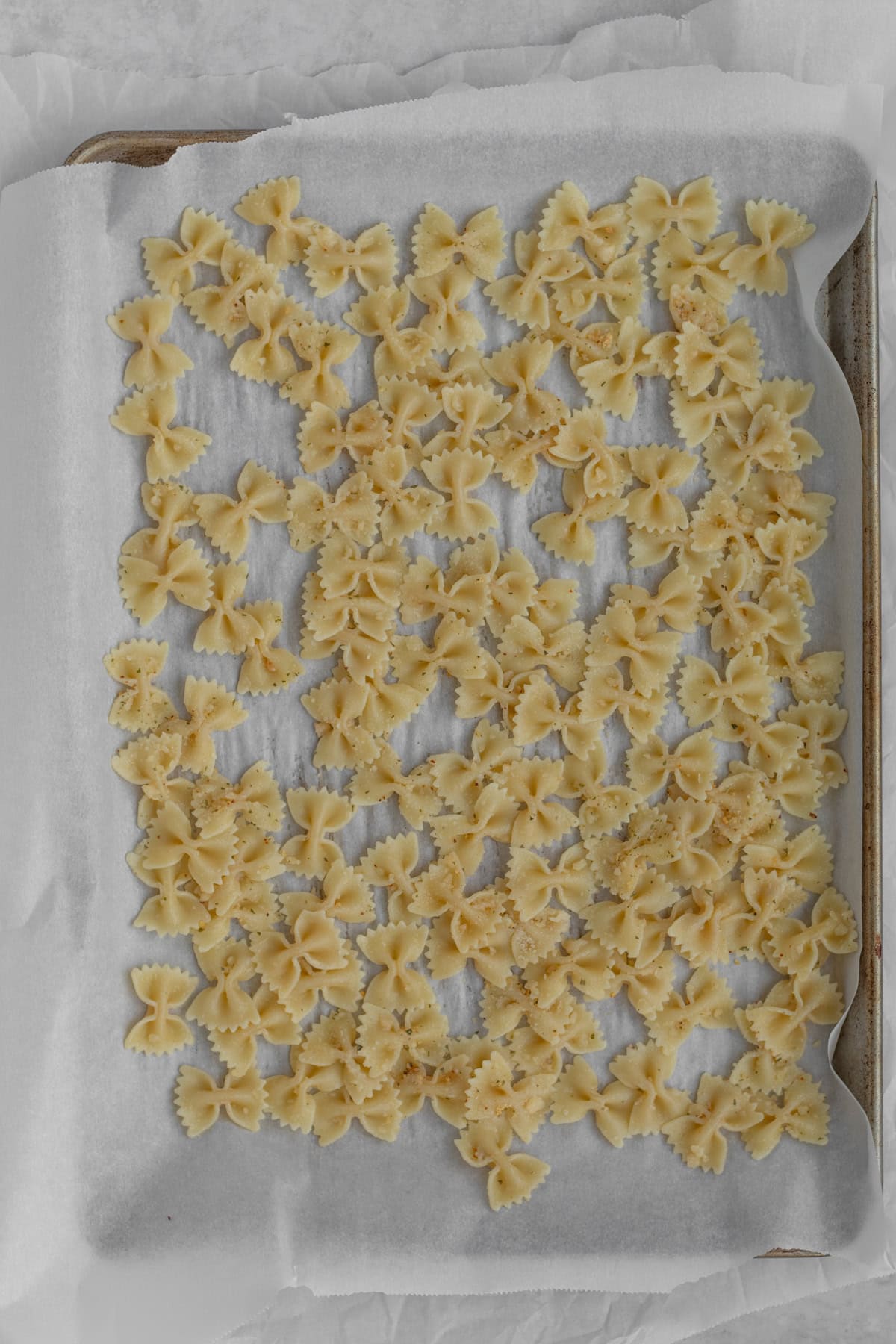 cooked pasta on a baking sheet.