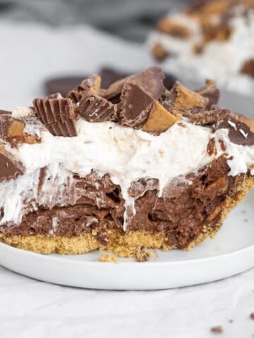 chocolate peanut butter cup pudding pie on a white plate.