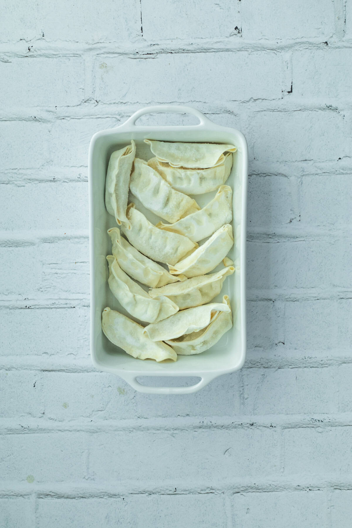 frozen potstickers in a baking dish.