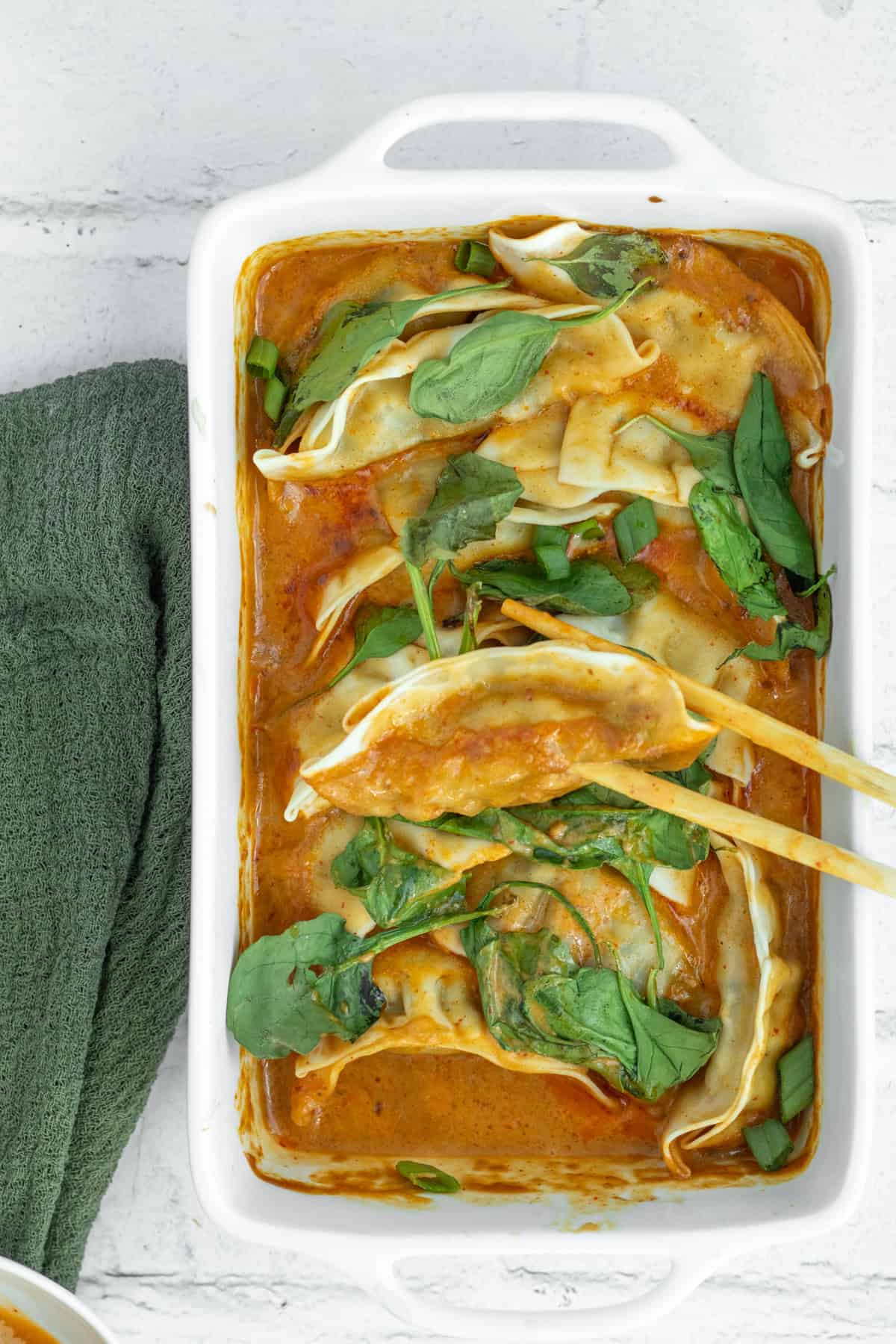 potstickers being held with chopsticks.