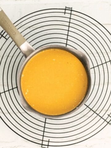 thai red curry sauce in a pot on a cooling rack